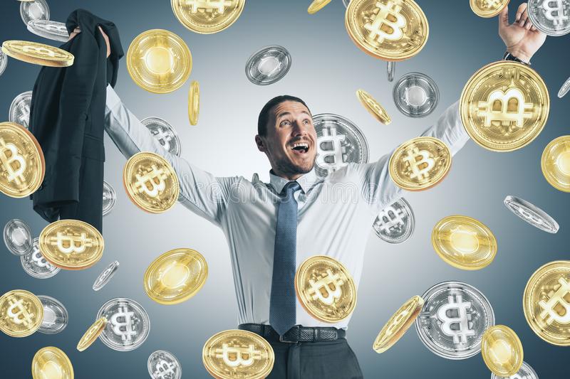 Picture of a businessman smiling as it rains bitcoins