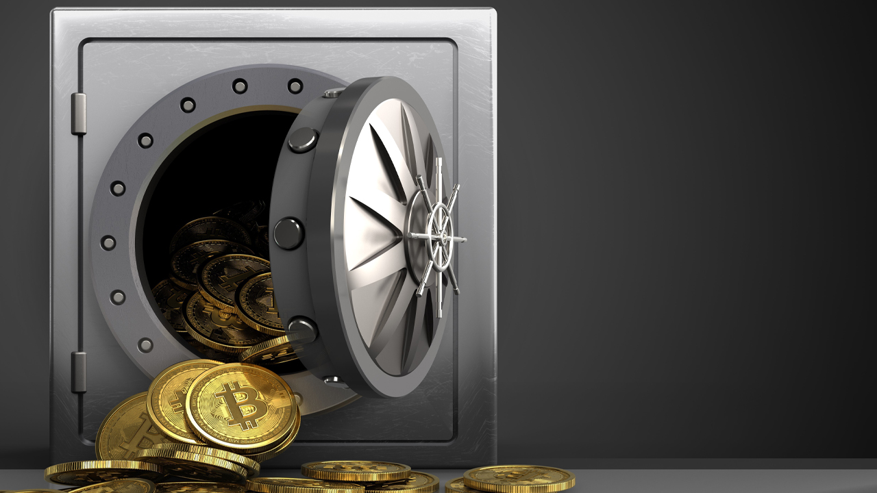 Picture of a vault with bitcoins pouring out of it